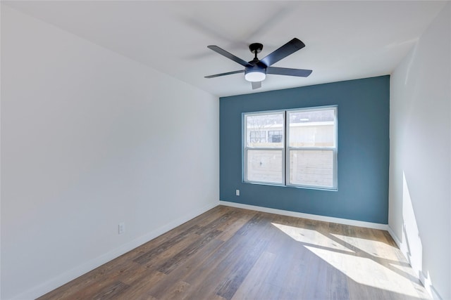 empty room with ceiling fan and dark hardwood / wood-style floors