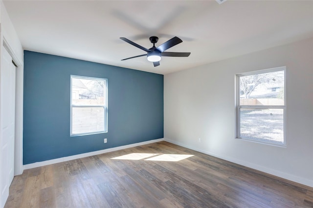 spare room with hardwood / wood-style flooring and ceiling fan