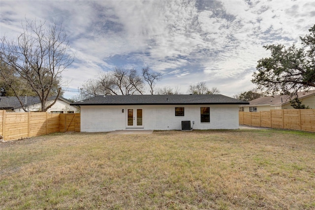 back of property featuring a lawn, french doors, and central AC unit