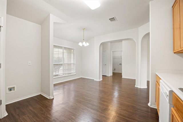 unfurnished dining area with dark hardwood / wood-style flooring and an inviting chandelier