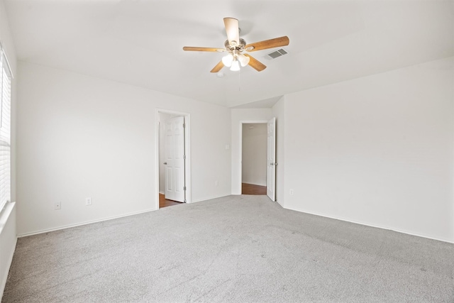 spare room featuring carpet flooring and ceiling fan