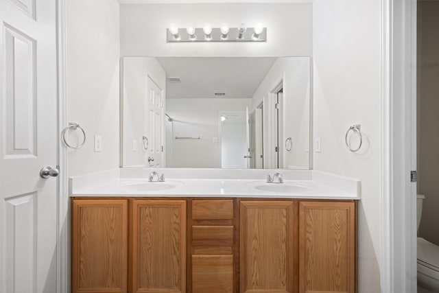 bathroom featuring toilet and vanity