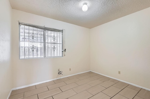 spare room featuring a textured ceiling