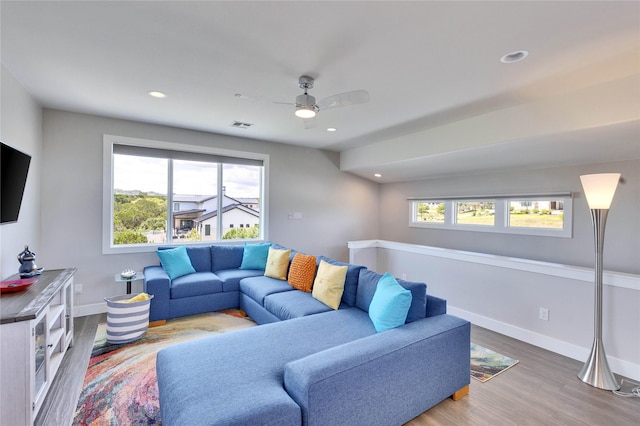 living room with ceiling fan and hardwood / wood-style floors