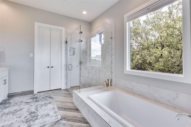 bathroom featuring separate shower and tub and vanity