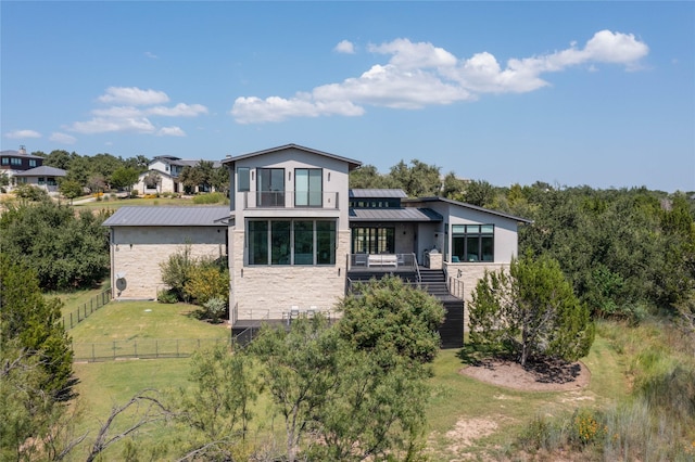 rear view of property featuring a yard