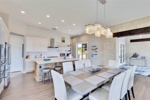 dining space featuring sink and light wood-type flooring