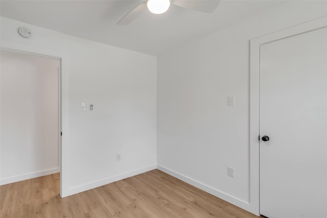 empty room featuring ceiling fan and light hardwood / wood-style floors