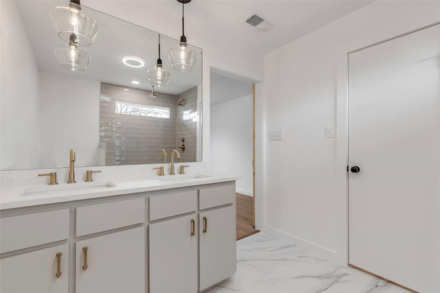 bathroom featuring vanity and tiled shower