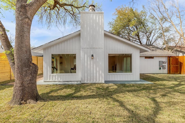 rear view of property featuring a yard