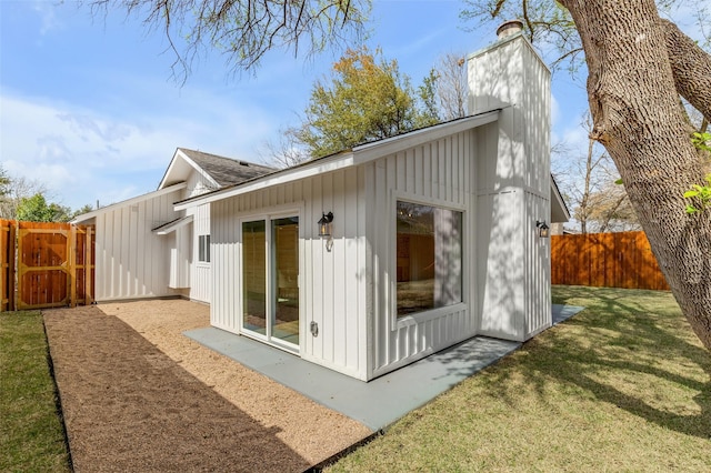 view of side of property with a lawn