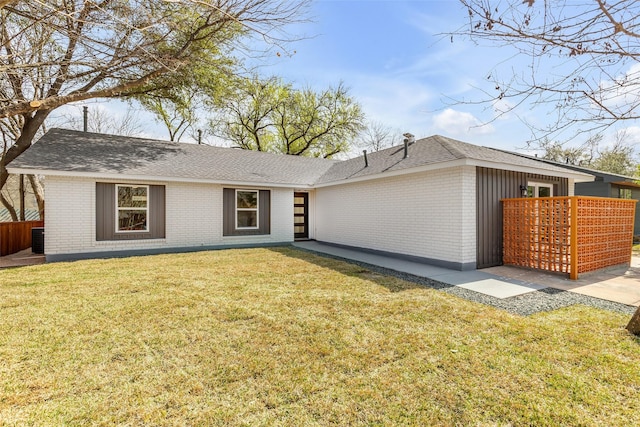 ranch-style house featuring a front yard and central air condition unit