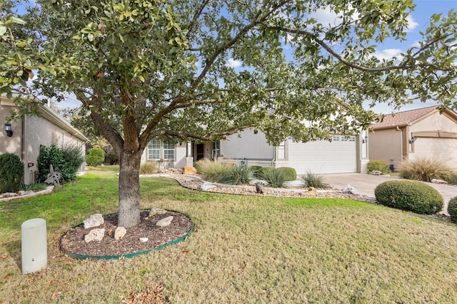 view of front of home with a garage and a front lawn