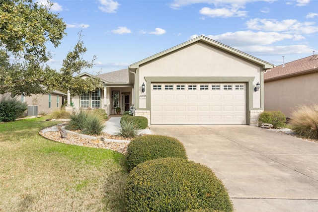 ranch-style house featuring a garage, cooling unit, and a front lawn