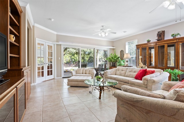 tiled living room with ornamental molding, ceiling fan, and french doors