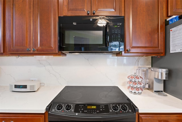 kitchen featuring black appliances and light stone countertops