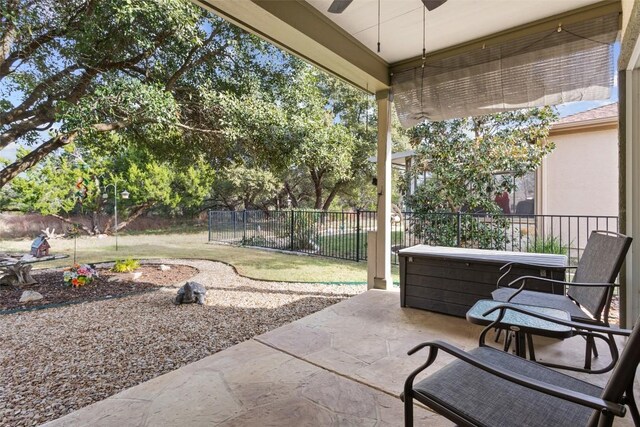 view of patio with ceiling fan and a jacuzzi