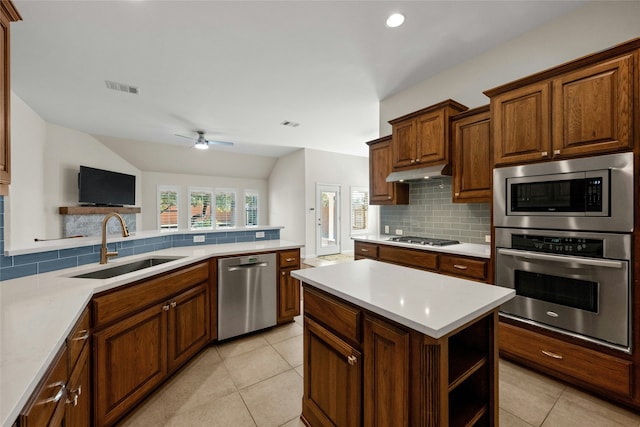 kitchen featuring stainless steel appliances, light tile patterned flooring, sink, and tasteful backsplash