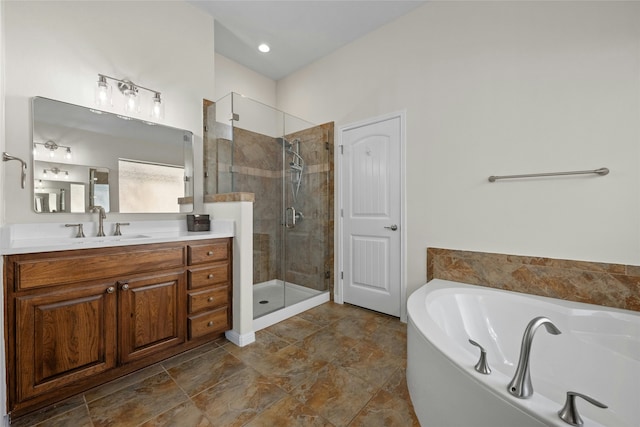 bathroom featuring shower with separate bathtub and vanity