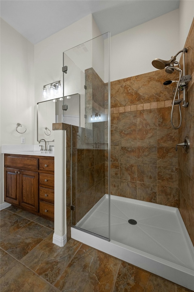 bathroom with a shower with door and vanity