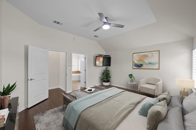 bedroom with vaulted ceiling, dark hardwood / wood-style flooring, connected bathroom, and ceiling fan