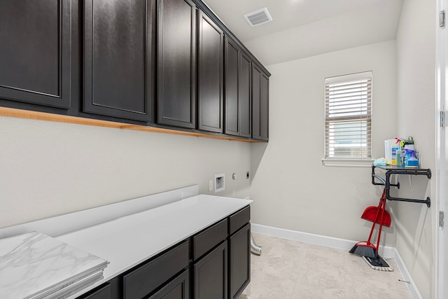 clothes washing area with hookup for a washing machine and cabinets