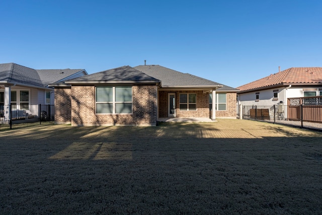 rear view of property featuring a lawn and a patio area