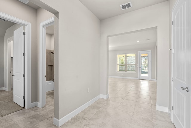 corridor featuring light tile patterned floors