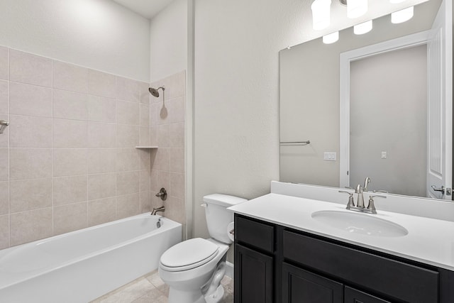 full bathroom featuring vanity, tile patterned flooring, tiled shower / bath combo, and toilet