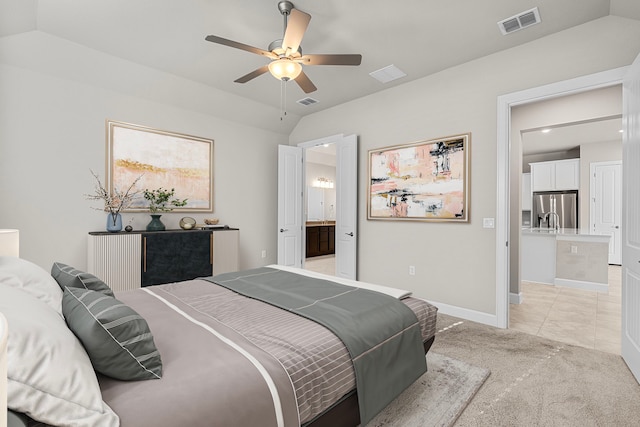 bedroom with light carpet, ensuite bath, ceiling fan, stainless steel fridge, and lofted ceiling