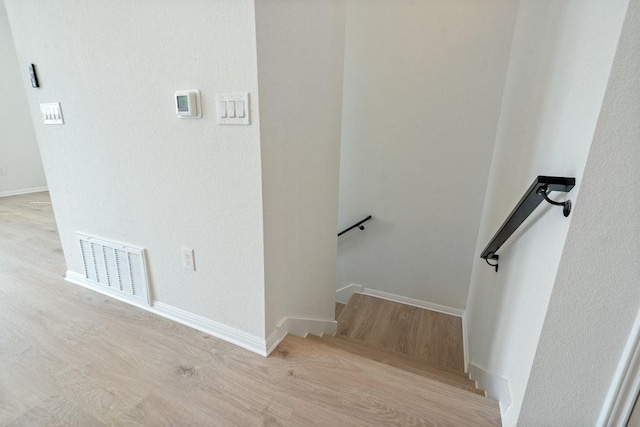 stairway with wood-type flooring