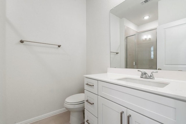 bathroom featuring walk in shower, vanity, toilet, and tile patterned flooring