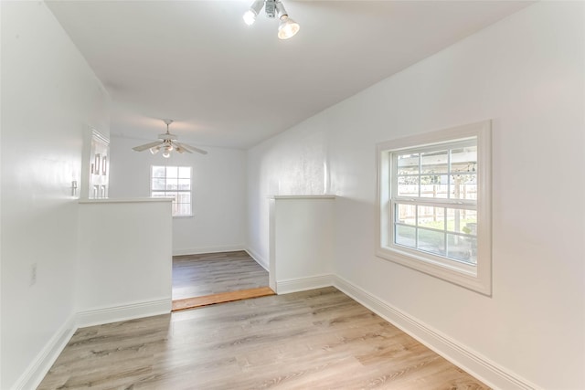 empty room featuring ceiling fan and light hardwood / wood-style flooring