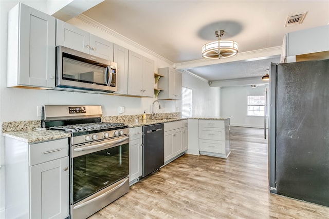 kitchen featuring light stone counters, stainless steel appliances, light hardwood / wood-style floors, ornamental molding, and sink