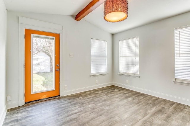 entrance foyer with hardwood / wood-style flooring and vaulted ceiling with beams