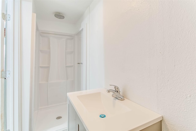 bathroom with vanity and walk in shower