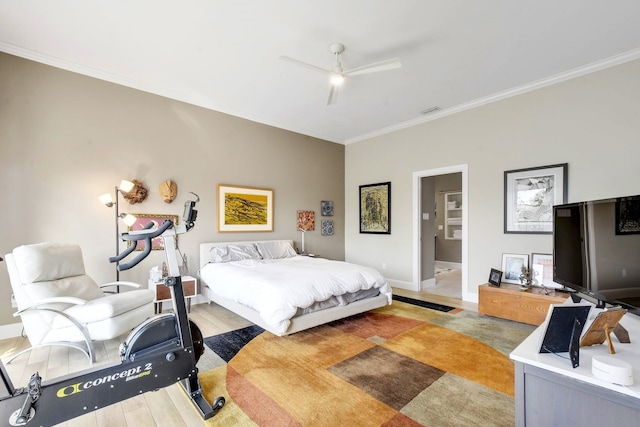 bedroom with ensuite bathroom, ceiling fan, hardwood / wood-style flooring, and ornamental molding