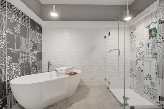 bathroom with tile walls, tile patterned flooring, and plus walk in shower