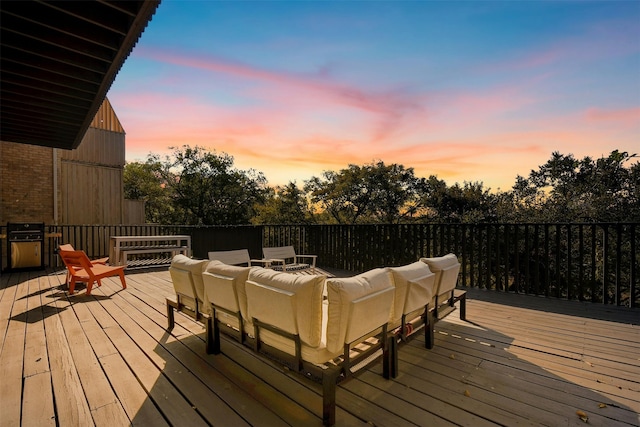 deck at dusk featuring outdoor lounge area