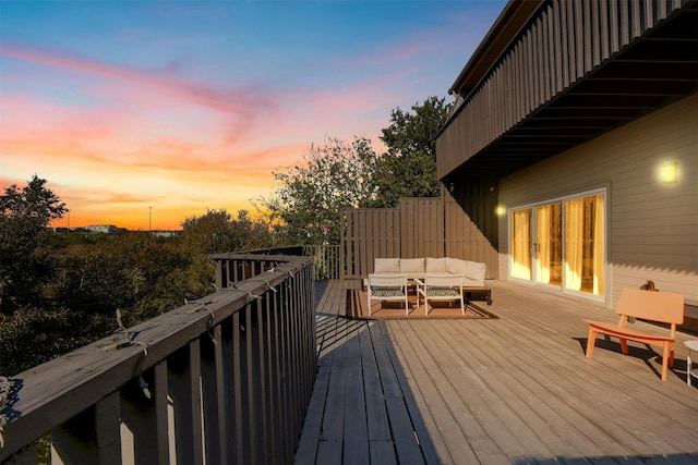 deck at dusk featuring an outdoor hangout area