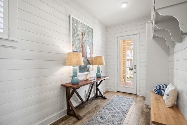 entryway with wood walls and hardwood / wood-style floors