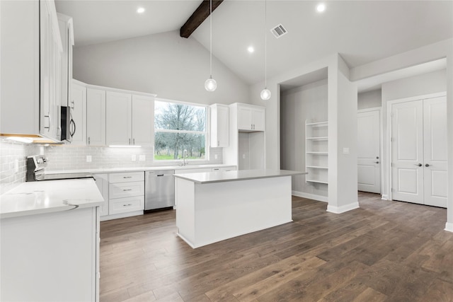 kitchen featuring appliances with stainless steel finishes, a center island, pendant lighting, and white cabinets