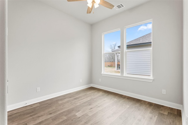 empty room with ceiling fan and light wood-type flooring