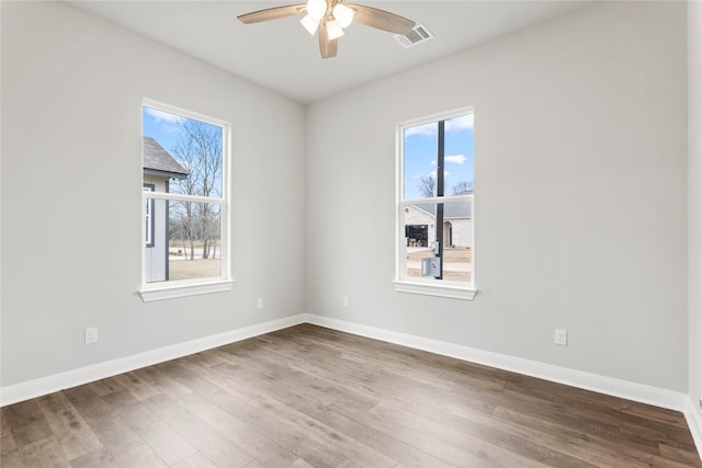 unfurnished room with ceiling fan, plenty of natural light, and hardwood / wood-style floors