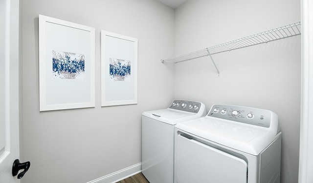 washroom featuring washing machine and dryer and hardwood / wood-style floors