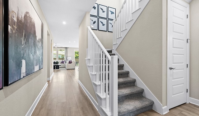 staircase with hardwood / wood-style flooring