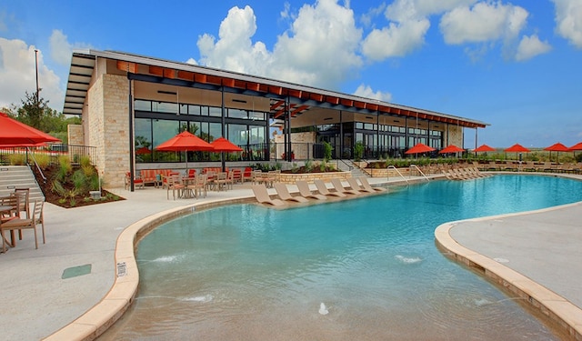 view of pool with pool water feature and a patio area