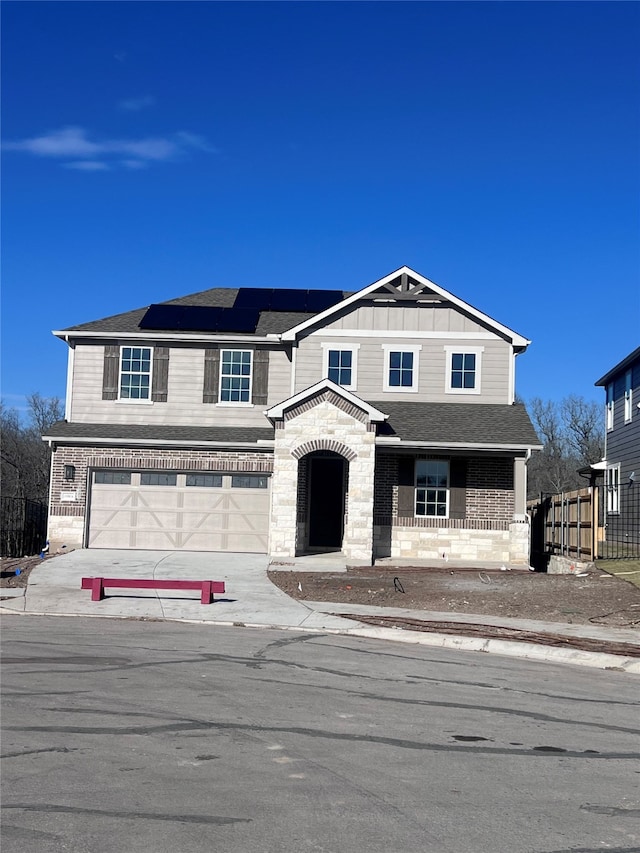 front facade with a garage and solar panels