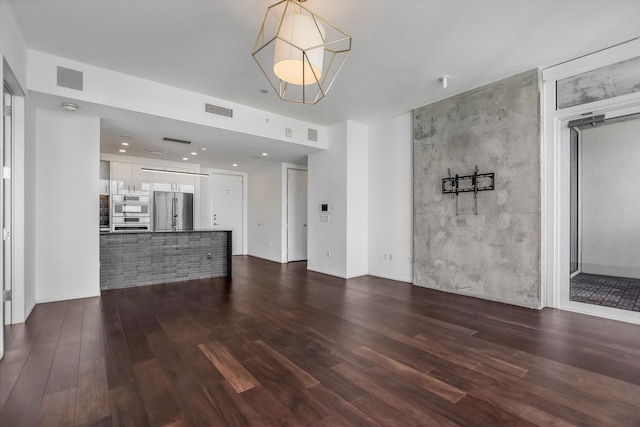 unfurnished living room with dark wood-type flooring