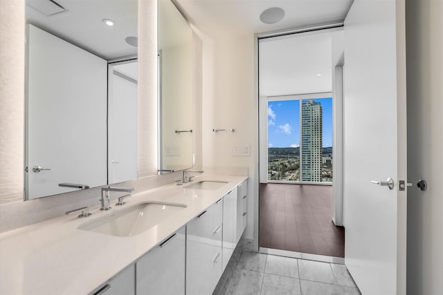 bathroom featuring vanity, tile patterned floors, and expansive windows